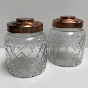 Two large, glass storage jars